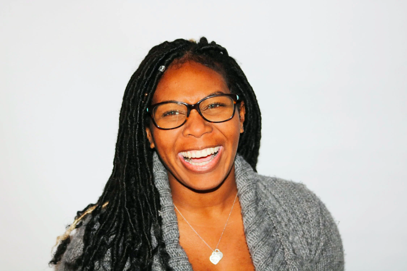 A happy older woman smiles while looking past the camera.