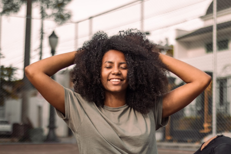 A woman’s laughing after getting non-surgical body sculpting